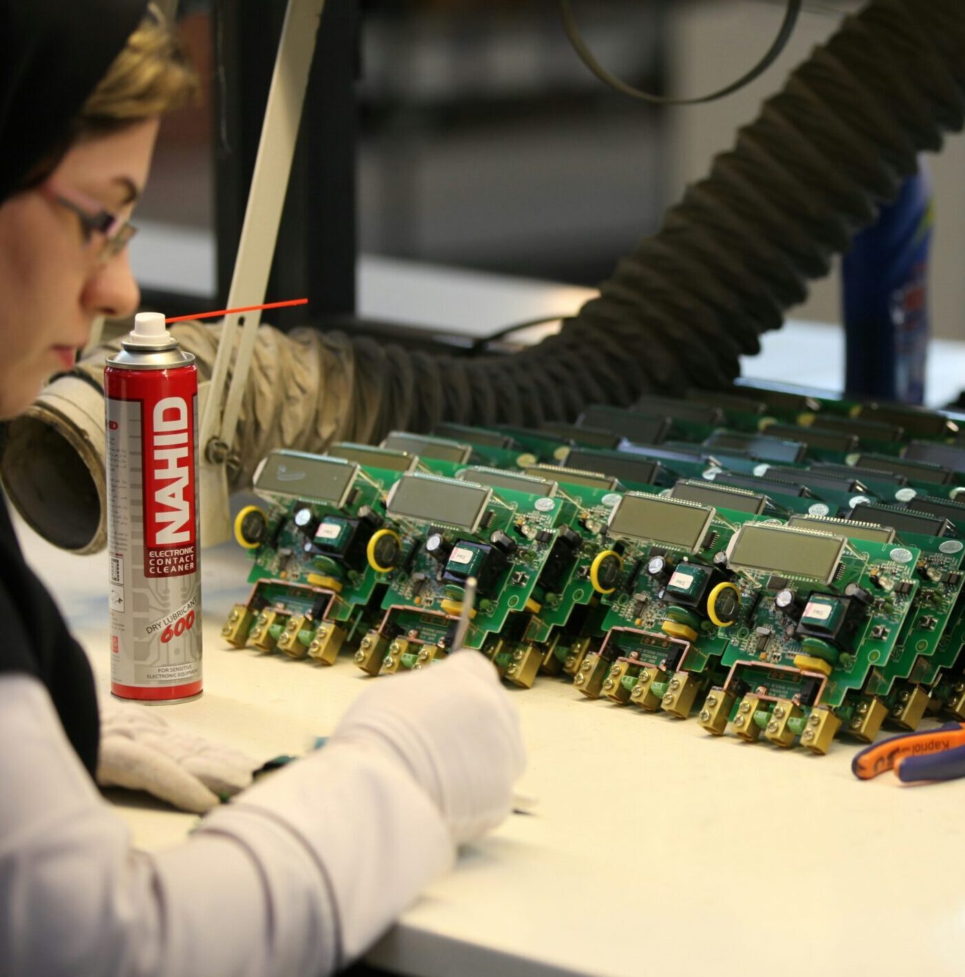 Electronics manufacturing technician working on PCB assembly